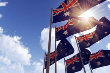 Australia flags waving in the wind against a blue sky. 3D Rendering