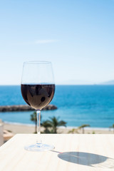 
Glass of red wine on a terrace near the Mediterranean sea, Aguilas, Murcia, Spain