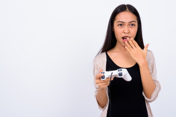 Portrait of young Asian woman playing games and looking shocked