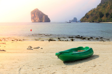 Small and green boat on sand at  seabeach