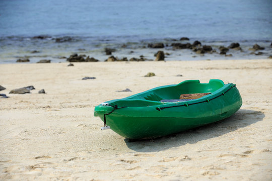 Small and green boat on sand at  seabeach
