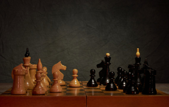 Black and white photo with a picture of a chess Board and chess pieces, Wooden chess pieces on a chess Board