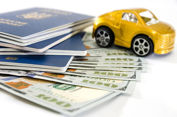 passports, dollars and toy car on a white background. travel concept.