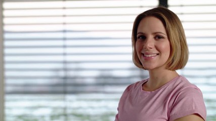 Portrait of pregnant woman indoors at home, doing exercise.