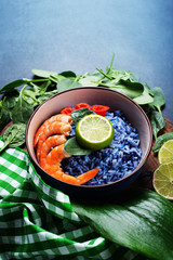 Blue rice with shrimp, lime and hot pepper. Place for text on top.