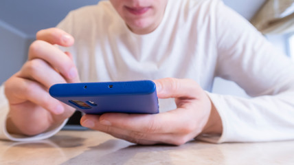 Mobile learning. Close up, Front view, Man using a mobile smartphone, technology, and lifestyle.