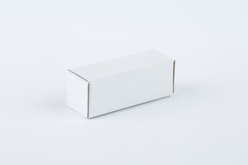 Close up of a small white cardboard box , isolated on white background