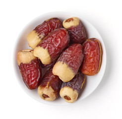 Bowl of dates isolated on white, from above
