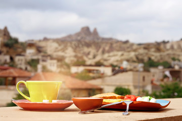 Breakfast on the balcony overlooking Uchisar Mountain in Cappadocia
