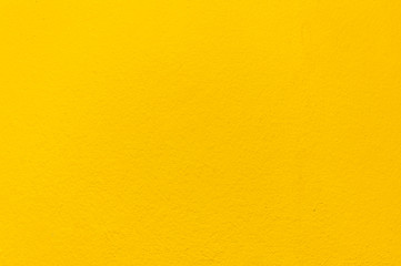 Blurred Yellow stucco wall background. Yellow painted cement wall texture.
