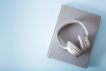 audiobook concept modern wireless headphones and book