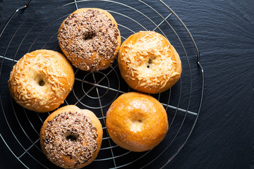 Food bakery concept Homemade organic bagels on black slate stone board with copy space