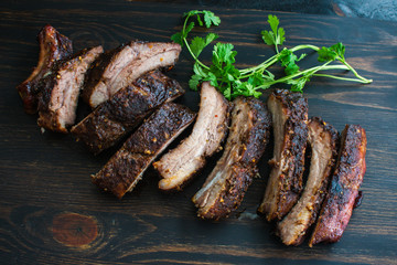 Jamaican Jerk Pork Ribs: Spicy barbecued baby back ribs on a wood cutting board