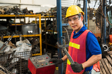 Asian Industrial workers are working on projects in large industrial plants with many devices.