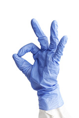 A human hand in a blue medical glove gestures a OK sign. Isolated on white.