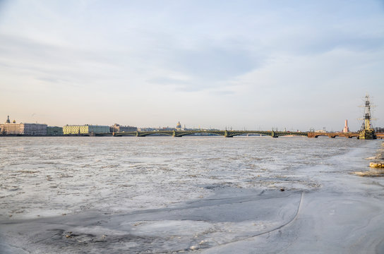 Panoramic view of Frigate Grace on the frozen Neva. Palace bridge on background. Cloudy winter day in Saint Petersburg, Russia