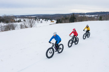 Aerial drone photo of a group of friends riding their fat bike in the snow in Ontario, Canada