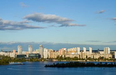 Landscape city view of left bank of Dnipro river with modern buildings in residential areas in Kyiv, Ukraine