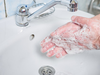 Man Wash hands with soap. Coronavirus protect. COVID-19 prevention