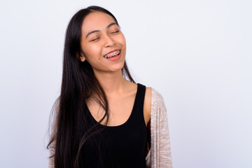 Fototapeta premium Portrait of happy young beautiful Asian woman with eyes closed
