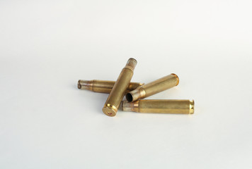 rifle bullet shell casings on white background