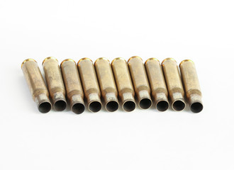 rifle bullet shell casings on white background