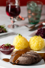 closeup of a german sauerbraten with dumplings
