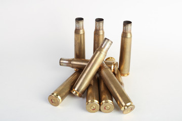 rifle bullet shell casings on white background