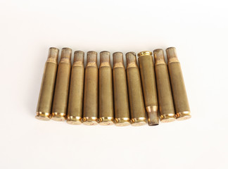 rifle bullet shell casings on white background