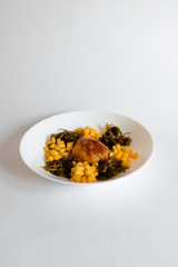 Fried chicken cutlet with potato slices served with tomato cherry and corn salad. Traditional belorussian food - roasted minced meat and potato