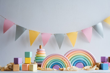 Wooden colorful toys. A wooden pyramid, rainbows and cubes.
