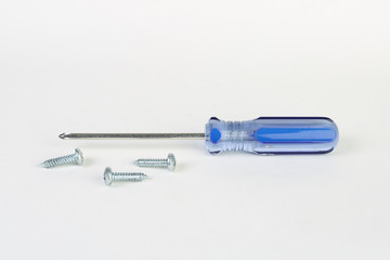 screws and a screwdriver on a white background