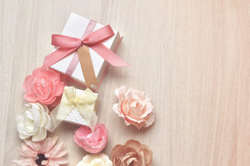 gift boxes and flowers Place on a white wooden table,for Mother's Day and Special day Presents,with copy space for text,pink rose and gift box