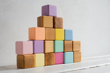 The wooden cubes are multicolored and natural. Children's cubes.