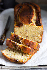 Banana muffin with candied ginger and raisins and drinks on a gray background.