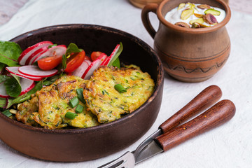 Zucchini fritters with green salad and Greek yogurt dipping sauce