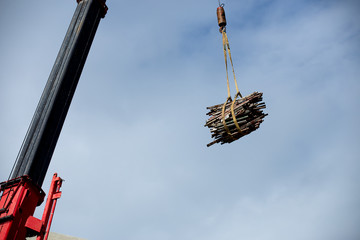 The crane driver is giving the crane for lift steel at construction site