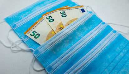 50 Euro bank note with protective surgical face masks