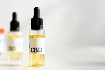 selective focus of bottle with oil and cbd lettering on table