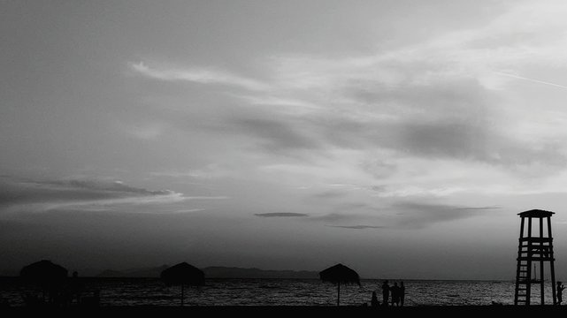 Silhouette Lifeguard Chair At Beach Against Sky