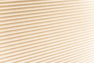 Carton or cardboard packing material. Texture of corrugated paper sheets made from cellulose. Supplies for creating boxes and packaging. Pasteboard background. Natural brown cardboard surface.