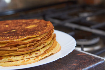 pancakes at the stove,baked pancakes by the gas stove in the kitchen