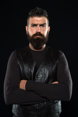 Strict mature face. Facial hair. Male face. Handsome face. Man with beard in black leather clothes....