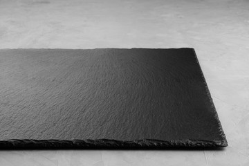 Slate Board on a gray background for placing products. Close up. © Роман Самсонов
