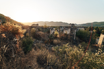 Fototapeta na wymiar The abandoned Greek village of Kayakoy, Fethiye, Turkey. Ghost Town Kayakoy. Turkey, evening sun. Ancient abandoned buildings of rock and stone.