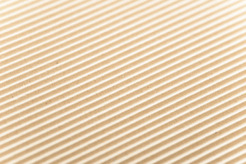Carton or cardboard packing material. Texture of corrugated paper sheets made from cellulose. Supplies for creating boxes and packaging. Pasteboard background. Natural brown cardboard surface.