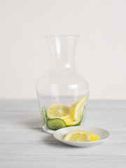 Jar with cucumber and lime slices inside for cucumber water recipe. Homemade detox concept. Vertical image