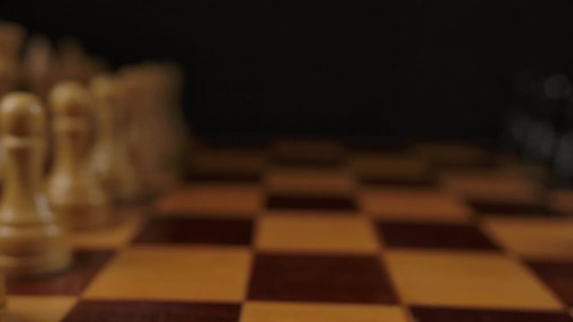 Panning shot of authentic wooden chess in beginning position. Ready for hard brain gaming. Close-up.