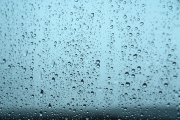 Window with raindrops in a stormy day
