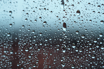 Window with raindrops in a stormy day